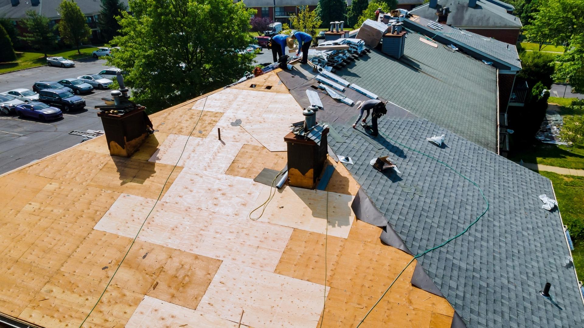 professionals working on roof of commercial property