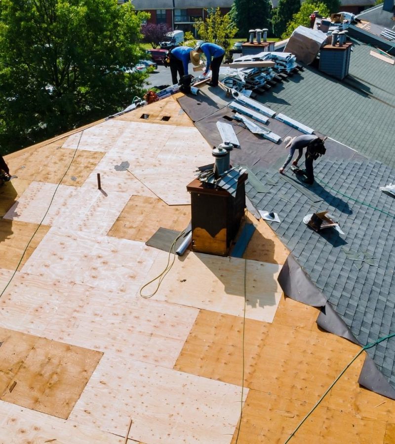 professionals working on roof of commercial property